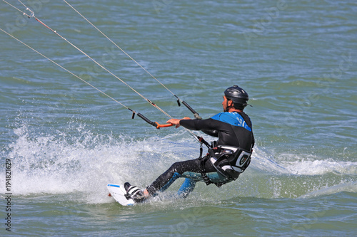 kitesurfer riding his board