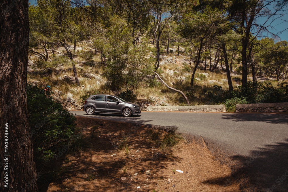 Grey car riding on the mountain and forrest road Grey car riding on the mountain and forrest road