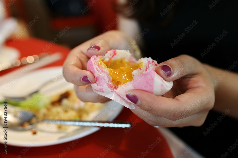 Asian woman hand hold cream bun with good luck Chinese new year