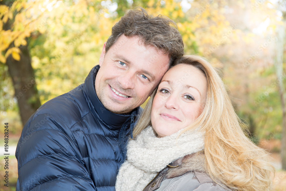 Couple in love leaves in a park enjoying beautiful autumn day Couple in love leaves in a park enjoying beautiful autumn day