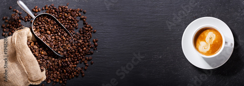 Fotografering cup of coffee and coffee beans in a sack, top view