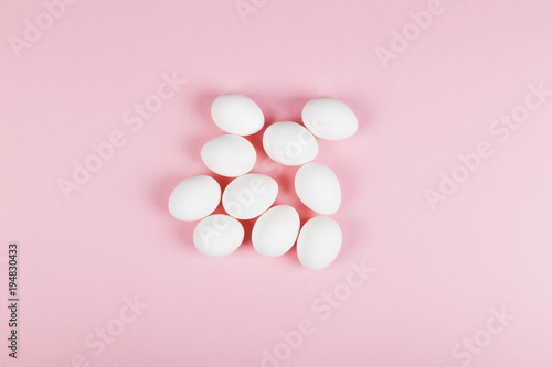 White egg on pink background. Top view
