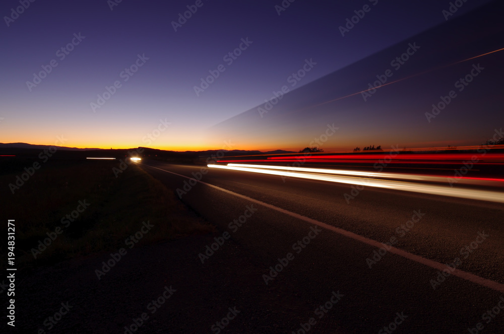 night scene with lights from car traffic on the road