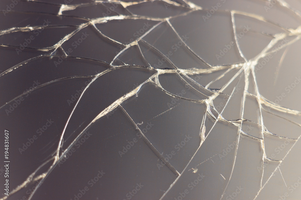 Close-up macro of broken dark glass. Abstract black background with white lines. Elements of smartphone (screen). Close-up macro of broken dark glass. Abstract black background with white lines. Elements of smartphone (screen).