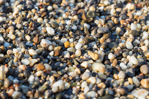 Colored pebbles at the coast sea. Beautiful beach and pebbles on mediterranean sea beautiful macro with a soft focus.