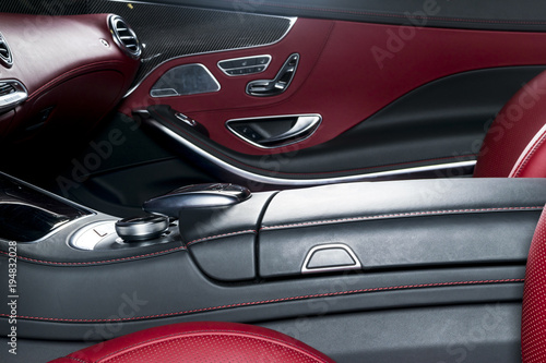 Modern Luxury car inside. Interior of prestige modern car. Comfortable leather seats. Red perforated leather cockpit. Modern car interior details
