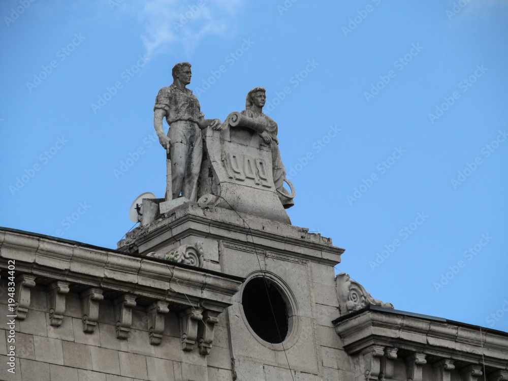 Ukraine, Zaporizhia - June 24, 2017: Soviet sculpture Worker and Peasant Woman 1949 by architect Georgy Orlov on the roof of a residential building at Soborny Avenue, 232