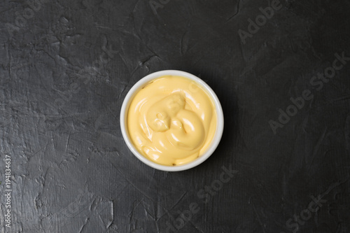 Cheese sauce on a black background. Place for your text.