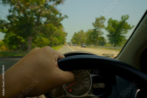 A man driving car on the country road