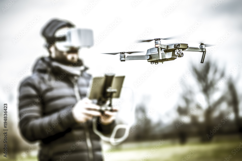 Young man with drone and virtual reality viewer