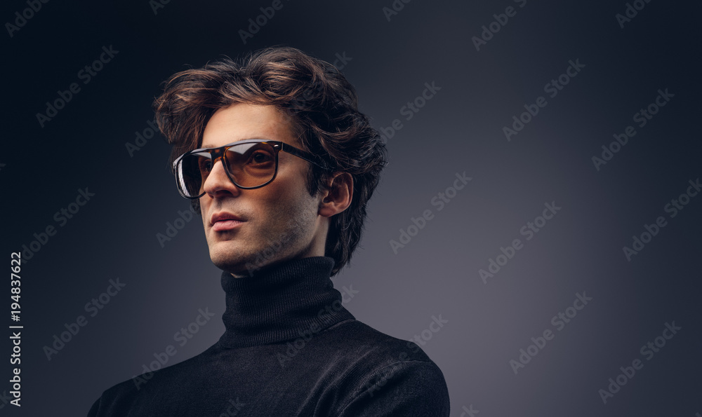 Studio portrait of a sensual macho male with stylish hair in a b Studio portrait of a sensual macho male with stylish hair in a b
