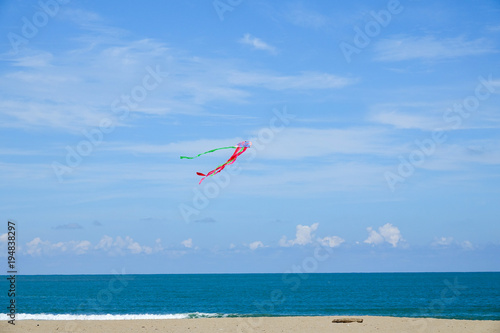 Colourful kite over  the blue sky.