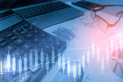 Calculator with business graphs and charts report , calculator on desk of financial planing. Financial abstract concepts.