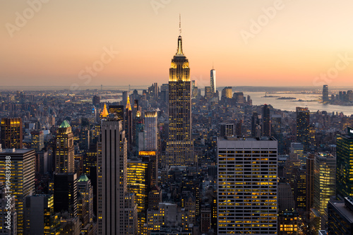 Golden sunset panoramic view of building and skyscrapers in Midtown and downtown skyline of lower Manhattan, New York City, USA.