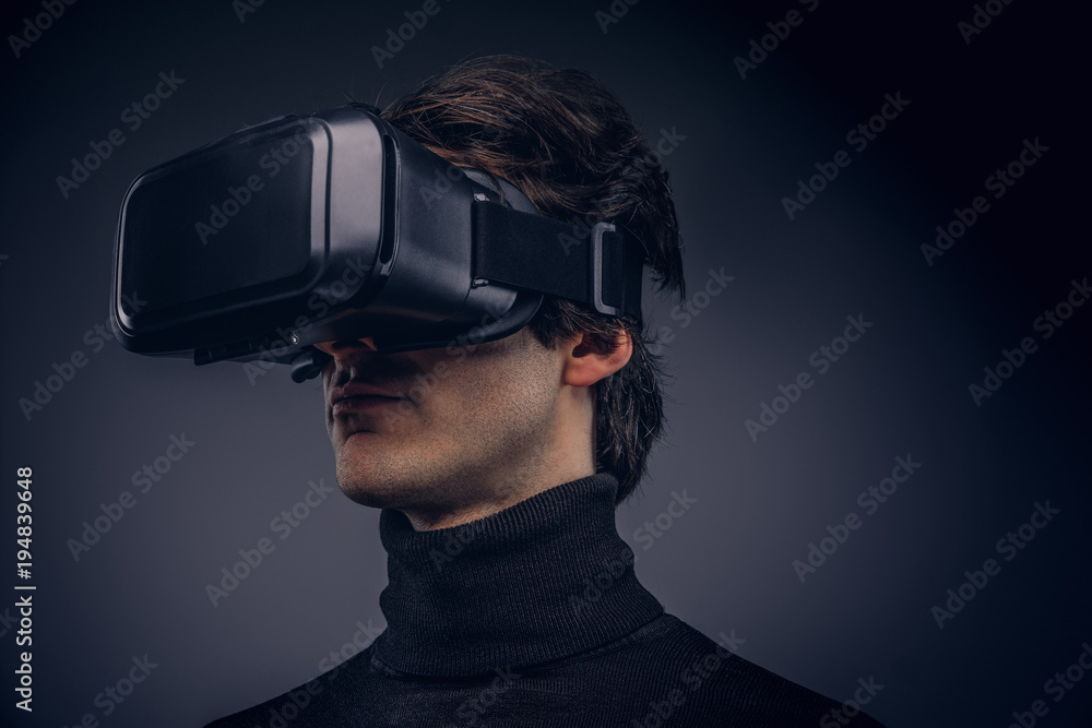Portrait of a man wearing virtual reality device isolated on a d Portrait of a man wearing virtual reality device isolated on a d