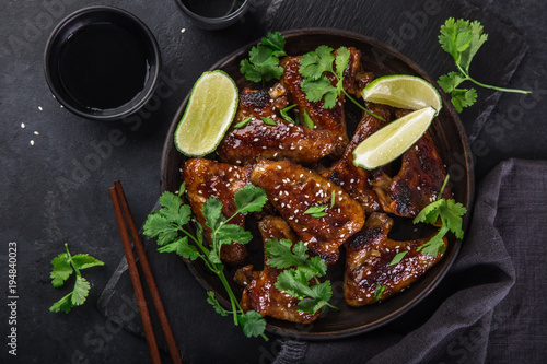 roasted teriyaki chicken wings, served with lime, cilantro and sesame seeds