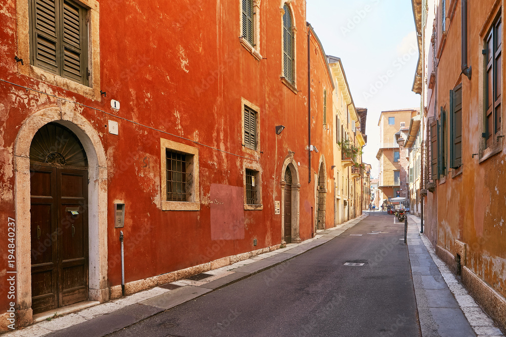 VERONA, ITALY - AUGUST 17, 2017: Narrow street of Verona high vibrant building facades.