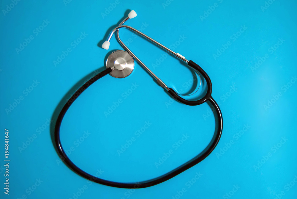 Stethoscope on a blue monophonic background, used in medicine Stethoscope on a blue monophonic background, used in medicine