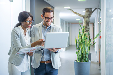 Business people with laptop discussing about new business offer for the company they received on email.