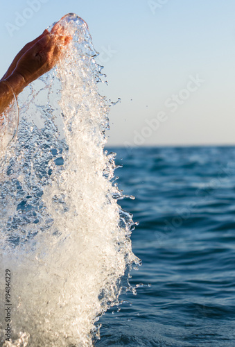 large transparent splashes sea water on a Sunny day