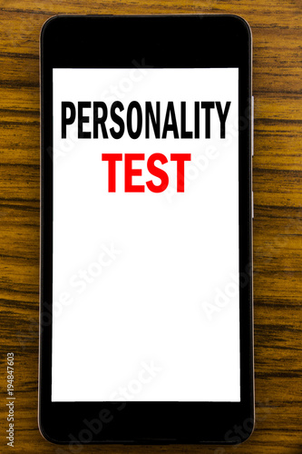 Handwriting Announcement text showing Personality Test. Business concept for Attitude Assessment Written on mobile phone cellphone with wooden background with space on the table photo