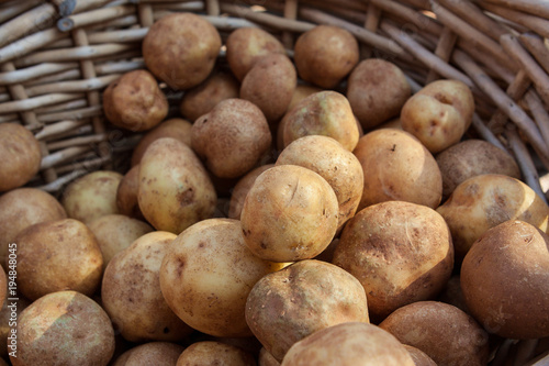 Wicker Basket Full Of Potatoes On Sale At Farmers Market