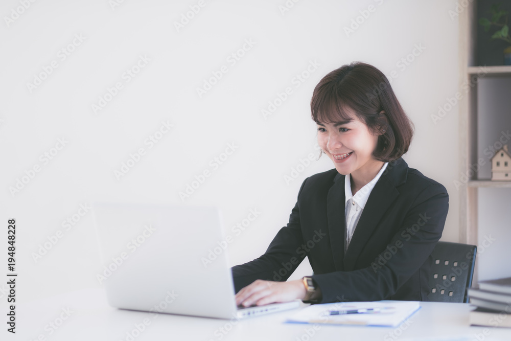 Young Asian woman working at a desk in business sector Young Asian woman working at a desk in business sector