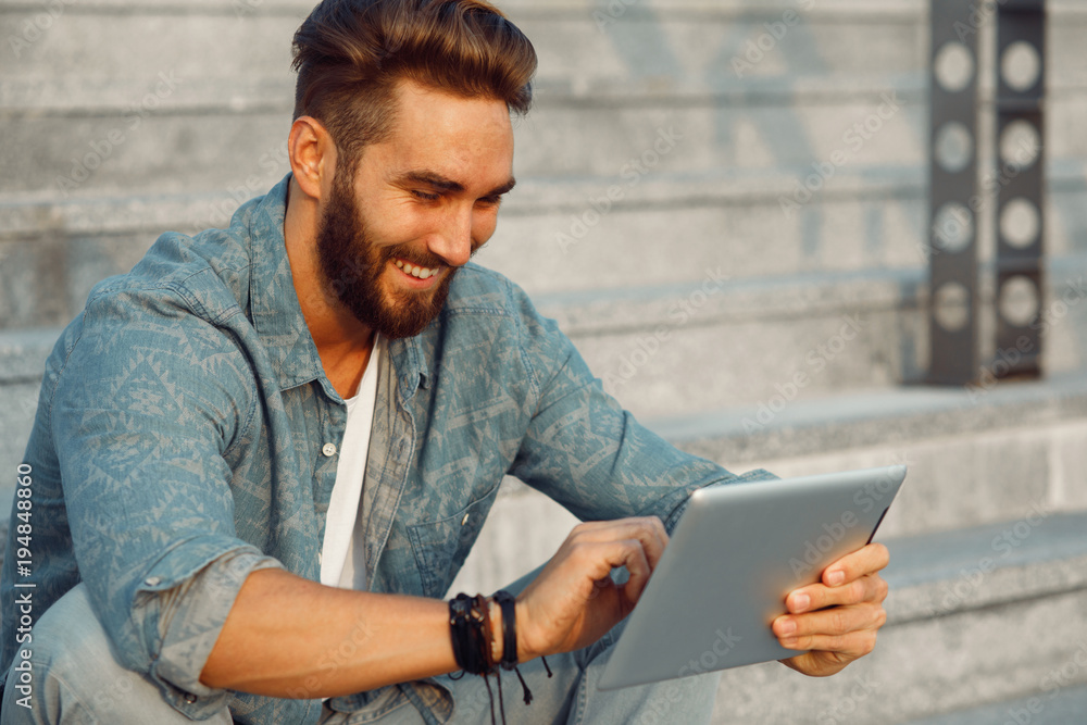 Young man using digital tablet outdoor Young man using digital tablet outdoor