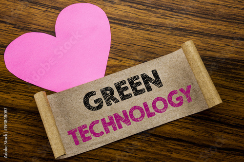 Writing text showing Green Technology. Business concept for campaign, written on sticky note paper, wooden wood background. With pink heart meaning love adoration. photo