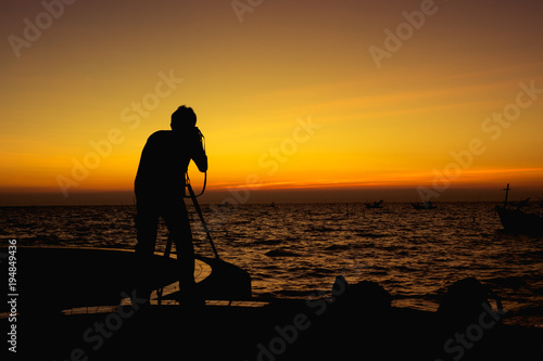Silhouette of photography man on the beach and sky with beautiful sunset.