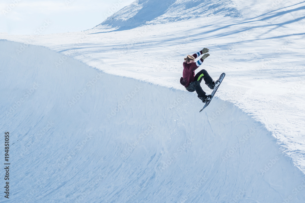 People are enjoying half-pipe skiing	/ snowboarding