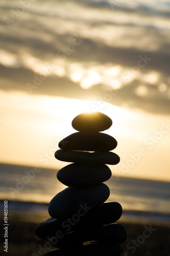 pebbles towered on the beach during the sunrise