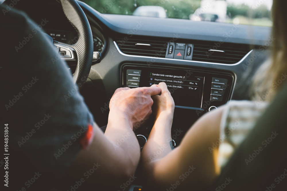 Couple holding hands in car