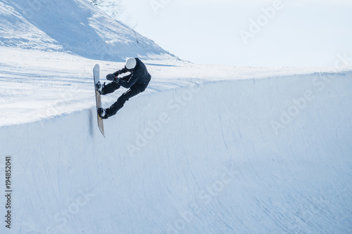 Vászonkép People are enjoying half-pipe skiing / snowboarding