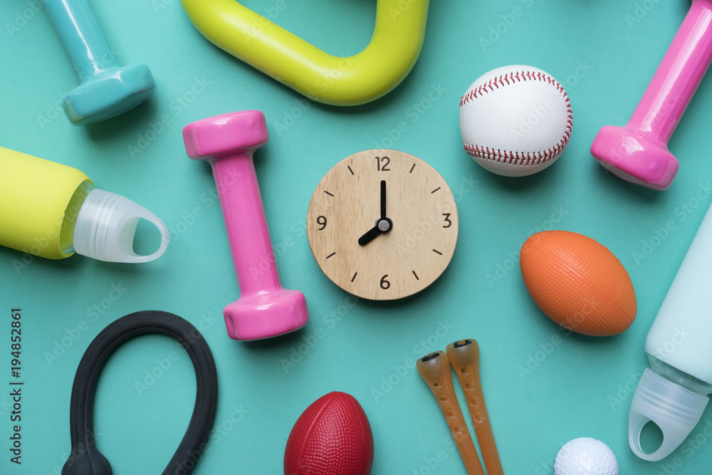 Time for exercising sport equipment with green background Time for exercising sport equipment with green background