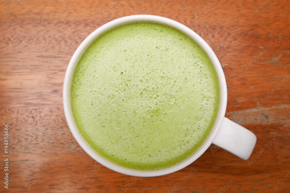 Top view of hot matcha green tea on wooden background Top view of hot matcha green tea on wooden background