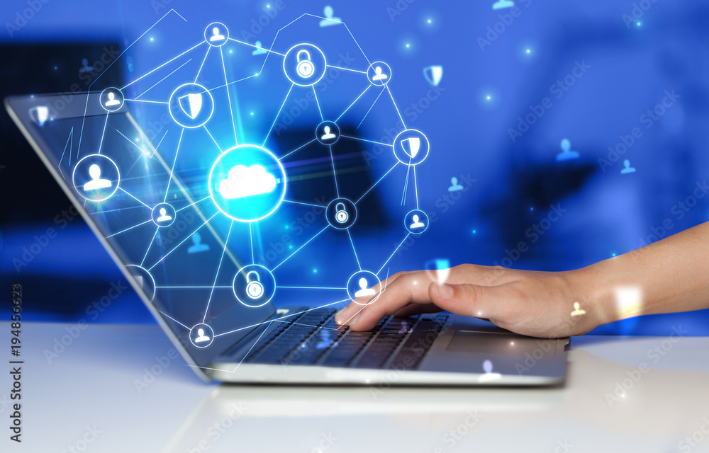 Hand using laptop with centralized linked cloud system concept Hand using laptop with centralized linked cloud system concept