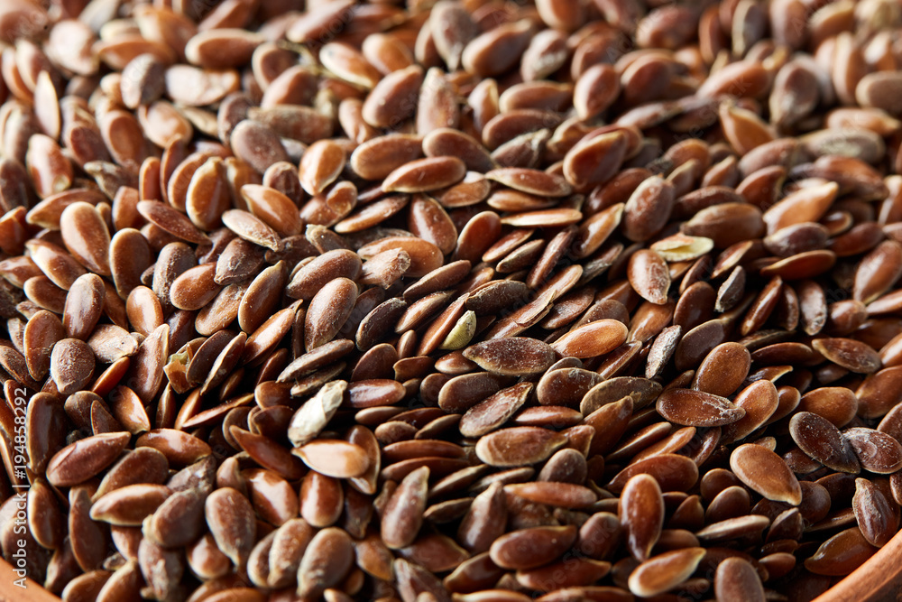 Top view close-up picture of separate flax seed on dark grey background, macro. Top view close-up picture of separate flax seed on dark grey background, macro.