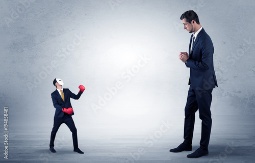 Businessman begging for small masked businessman