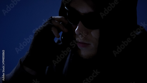 Canvas Print Dangerous criminal threatening victim by phone, demanding money via blackmail
