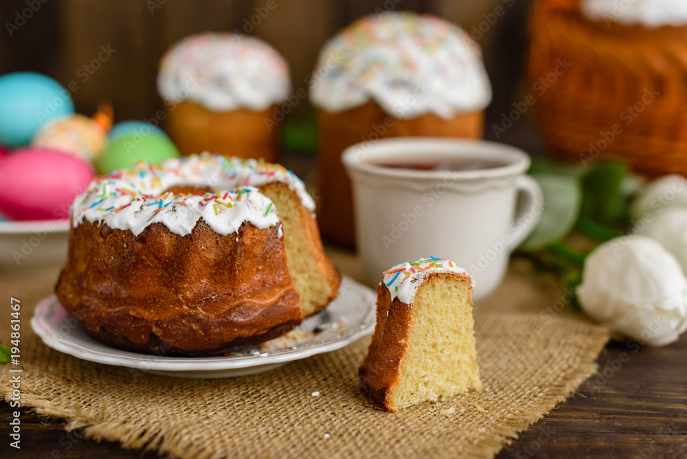 Easter cake and colorful eggs on a wooden table. It can be used as a background Easter cake and colorful eggs on a wooden table. It can be used as a background
