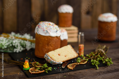 Easter cake and colorful eggs on a wooden table. It can be used as a background