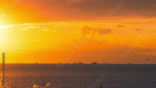 4k Time lapse of Manila bay sunset, with ships passing on horizon