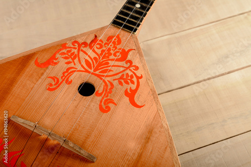 Bilde på lerret Russian musical instrument balalaika on a wooden table