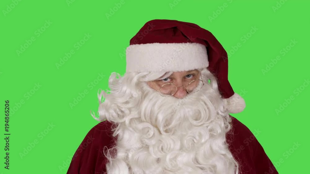Santa Claus on Green Screen Background Tilting Glasses Knowingly Santa Claus on Green Screen Background Tilting Glasses Knowingly