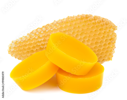 Pieces of natural beeswax and a piece of honey cell are isolated on a white background. Beekeeping products. Apitherapy. photo