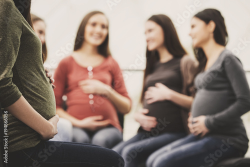 Happy pregnant women are talking together at antenatal class at the hospital photo
