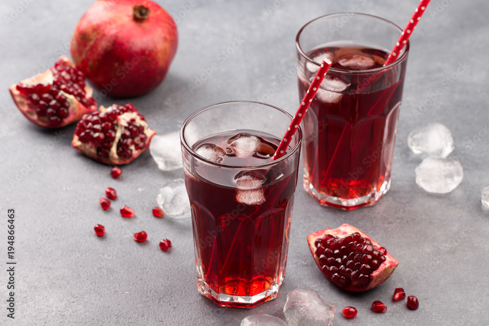 Fresh red lemonade with pomegranate and ice in glass Fresh red lemonade with pomegranate and ice in glass