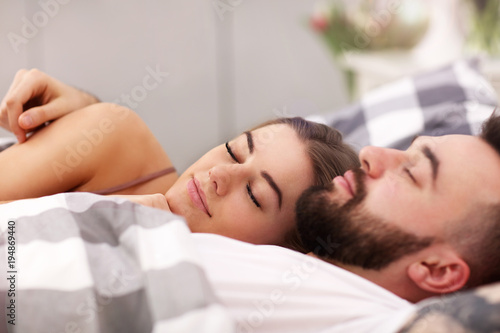 Adult attractive couple in bed