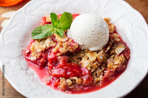 Crumble with berries and fruits with vanilla ice cream.